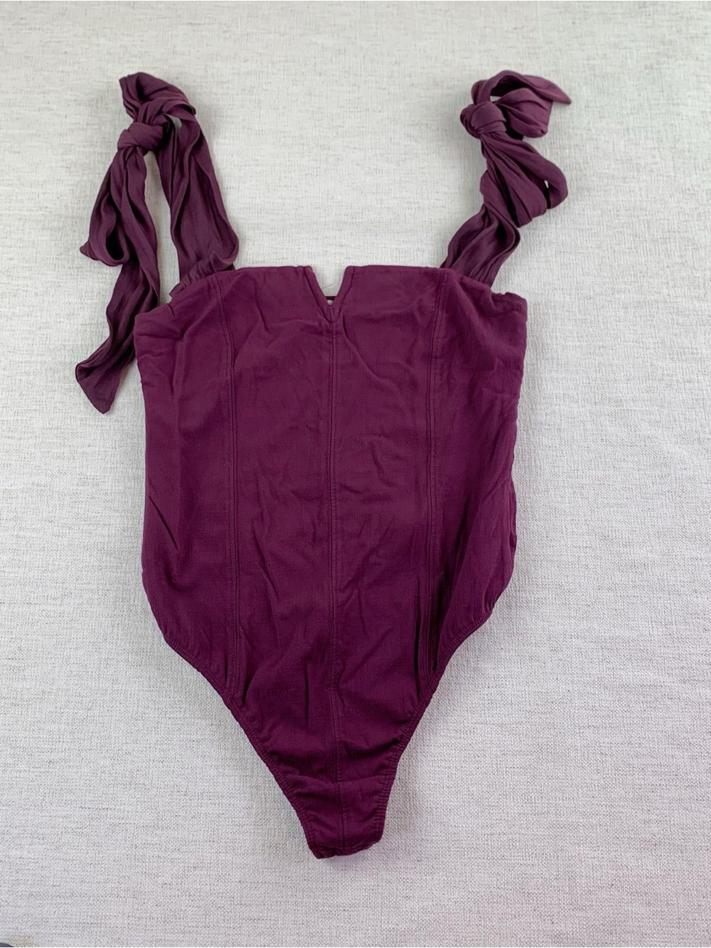 Intimate by Free People tie-shoulder bodysuit in burgundy V-notch neckline